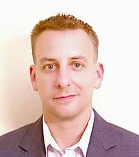 A person in a suit and tie

Description automatically generated